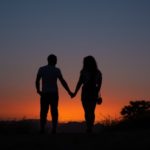 122209949-young-couple-enjoying-sunset-in-the-mountains-an-amorous-couple-at-sundown-